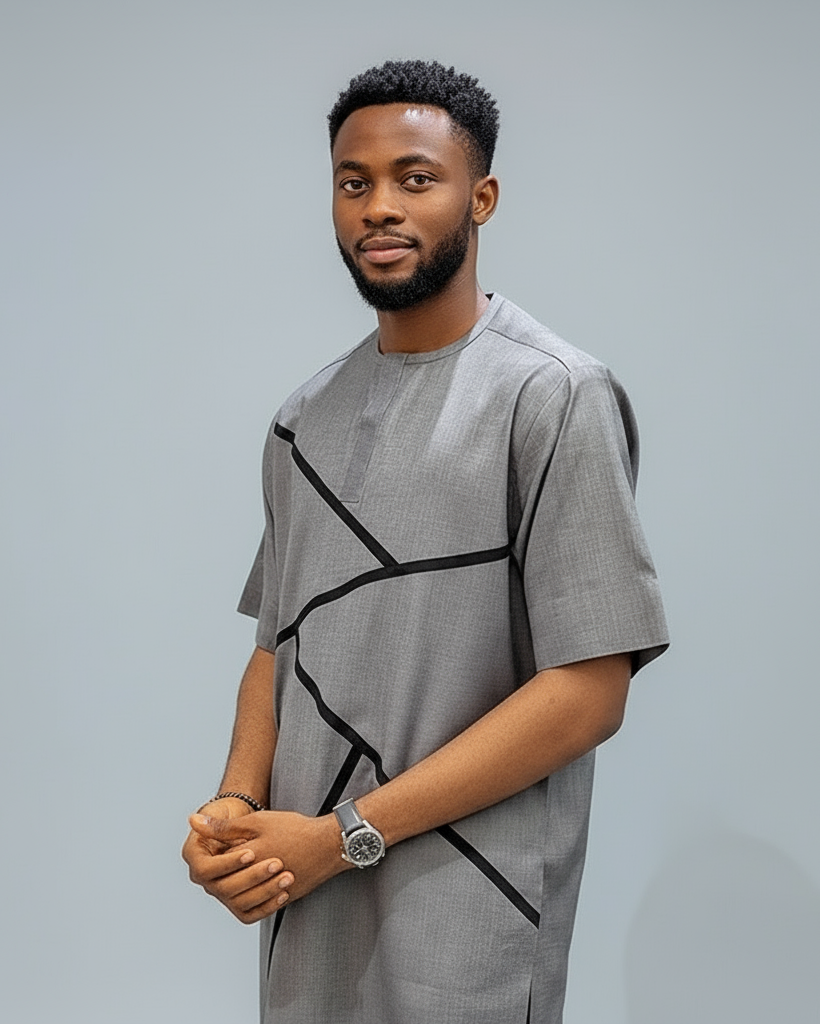 Man wearing a gray outfit with black geometric lines against a plain background