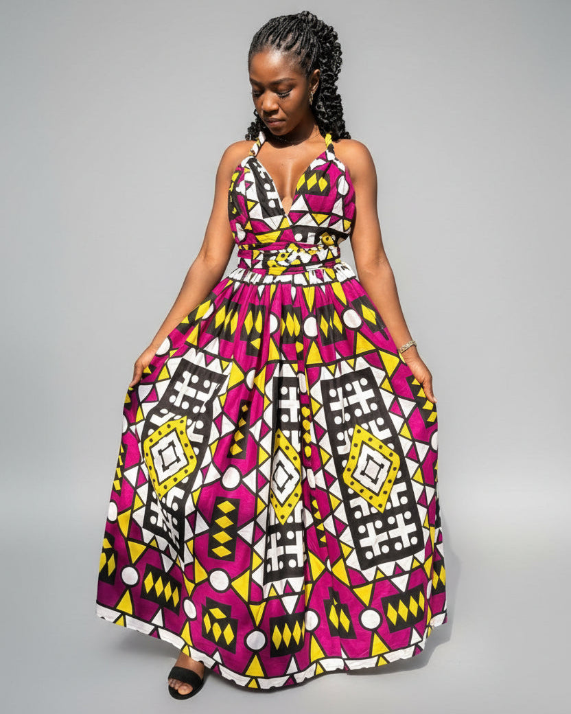 Woman wearing a colorful patterned dress on a gray background