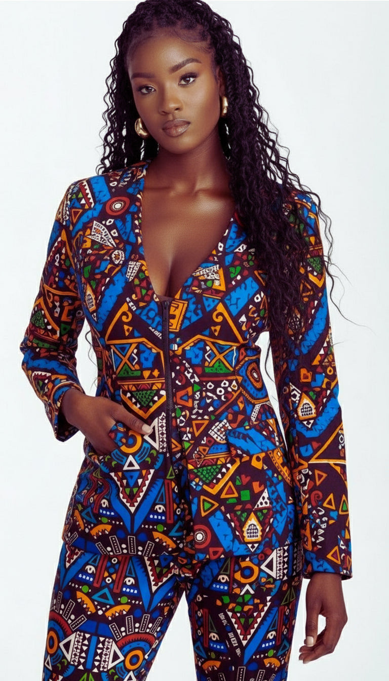 Woman wearing a colorful patterned jumpsuit on a gray background