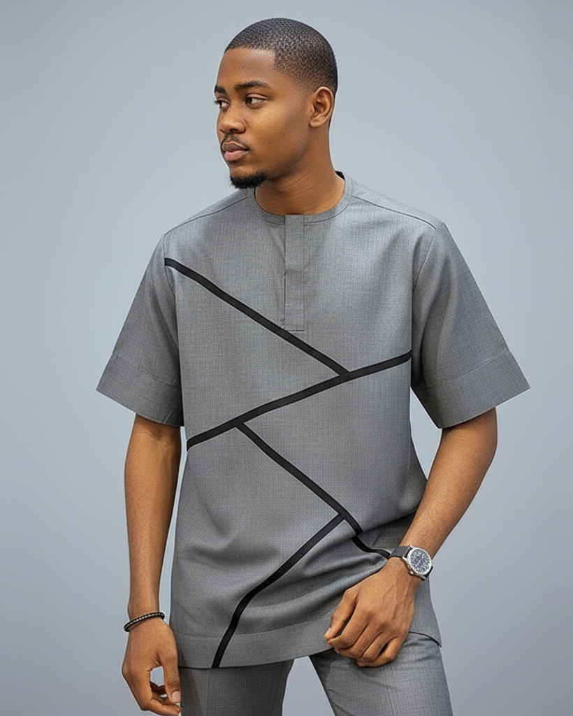 Man wearing a gray shirt with black geometric designs on a gray background