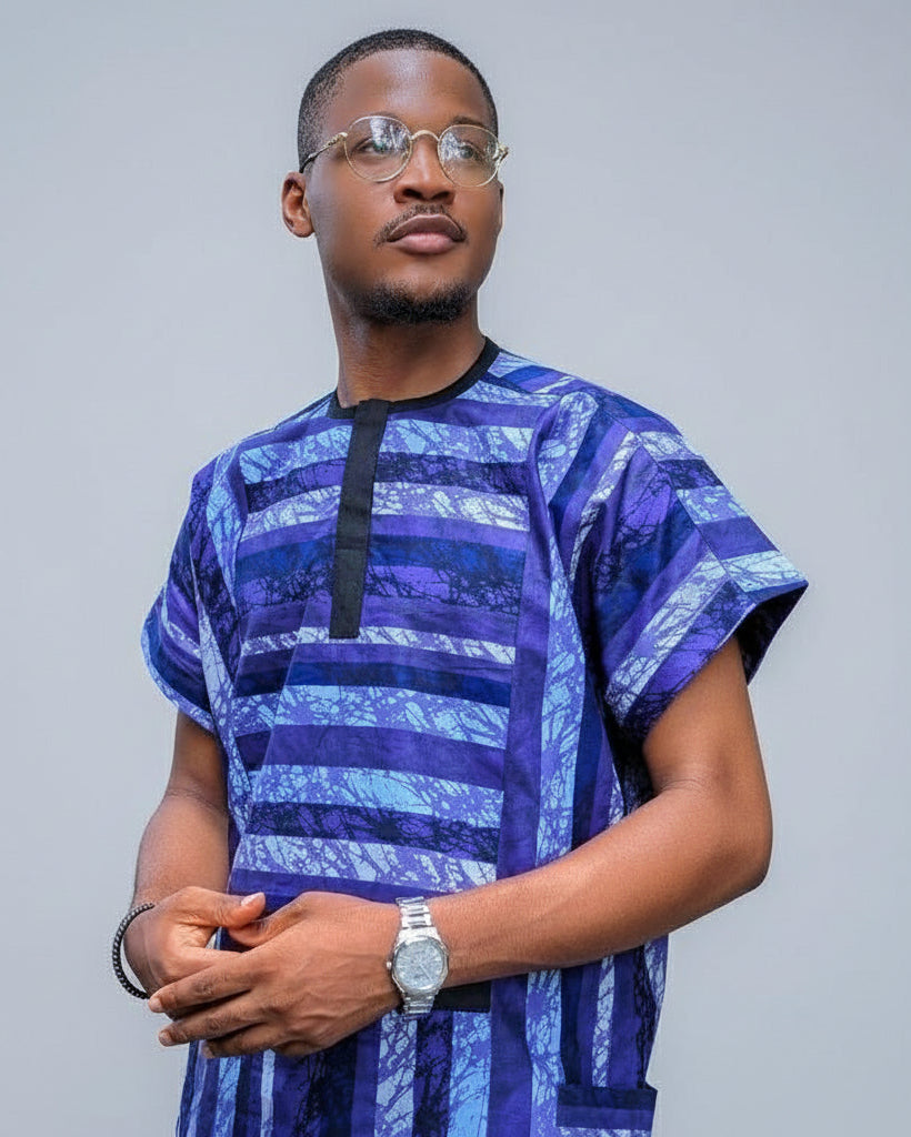 Man wearing a blue and purple patterned shirt against a gray background