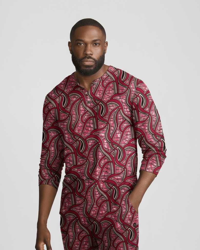 Man wearing a red and black patterned shirt on a grey background