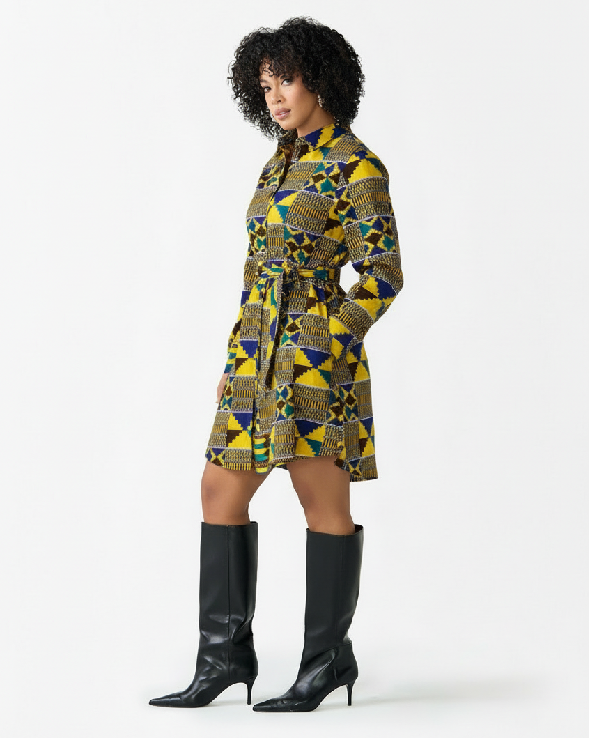 Woman wearing a patterned dress and black boots on a white background