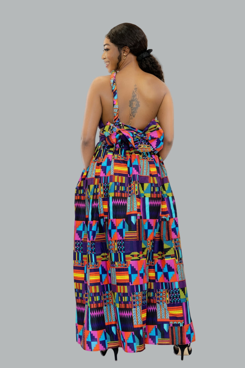 Woman wearing a colorful geometric patterned dress on a grey background